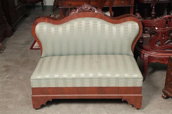 Appraisal: PAIR OF VICTORIAN FIRESIDE SETTEES Mahogany veneer with carved floral