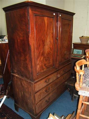 Appraisal: A Georgian mahogany linen press with two panelled doors above