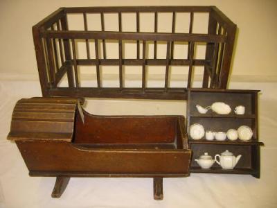 Appraisal: An old pine doll's cradle with moulded arched hood painted