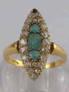 Appraisal: A hallmarked carat gold diamond and emerald marquise shape ring