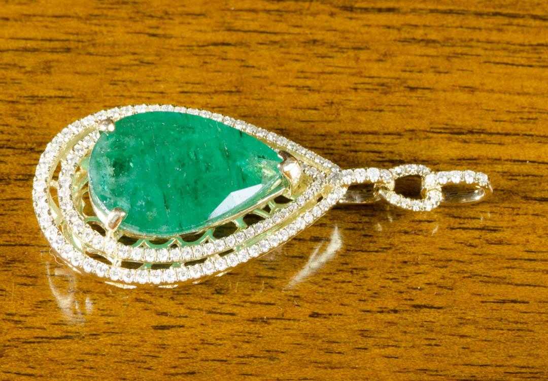 Appraisal: EMERALD DIAMOND AND FOURTEEN KARAT GOLD PENDANT with two rows