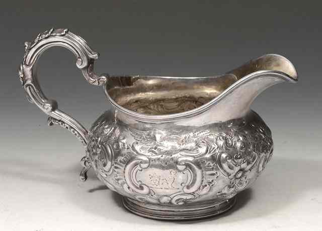 Appraisal: A VICTORIAN SILVER CREAM JUG with reeded edge and chased