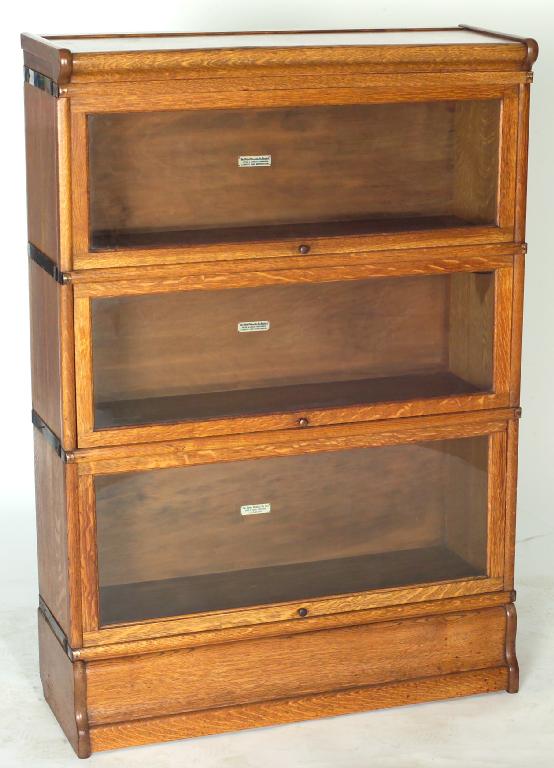 Appraisal: GLOBE WERNICKE GOLDEN OAK THREE-TIER BOOKCASE of characteristic form with