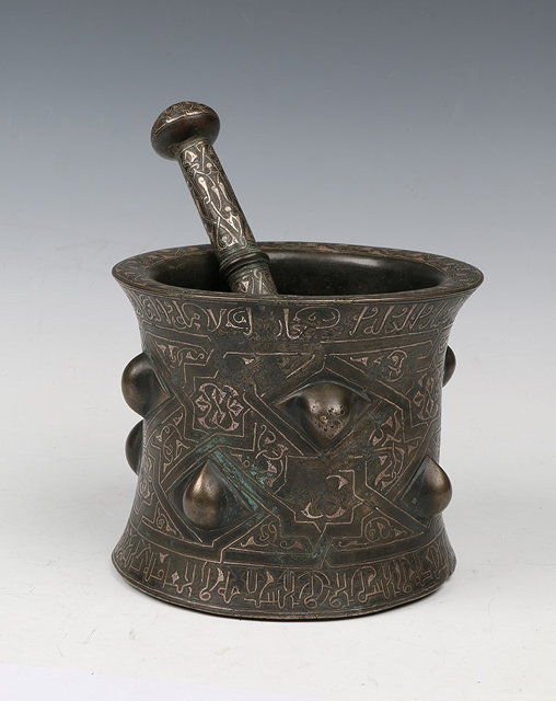 Appraisal: A TURKO-PERSIAN SELJUK EMPIRE BRONZE AND SILVER INLAID PESTLE AND