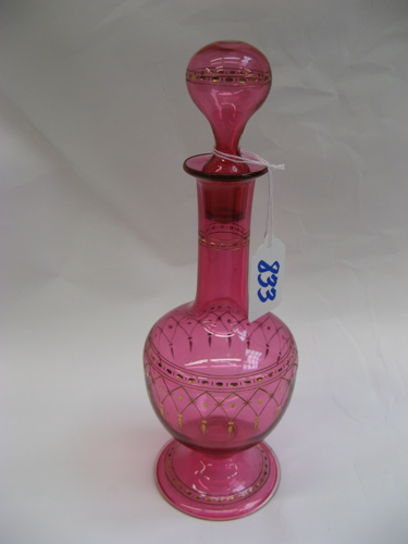 Appraisal: A CRANBERRY GLASS PERFUME BOTTLE with original bulbous stopper hand