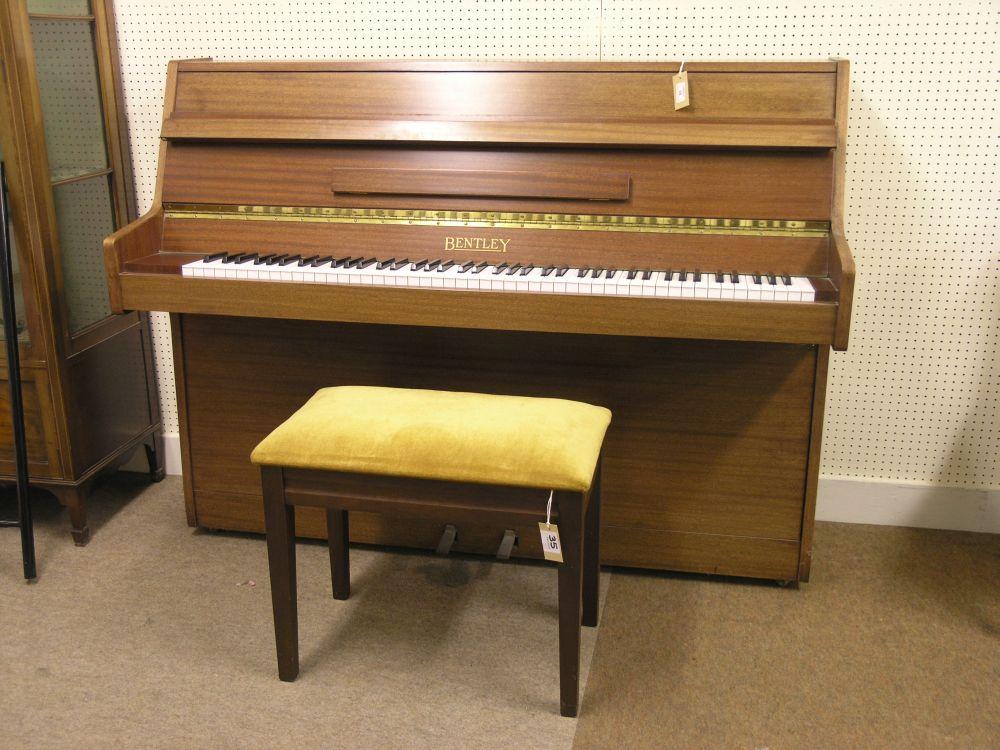 Appraisal: A modern Bentley upright piano iron framed and overstrung in