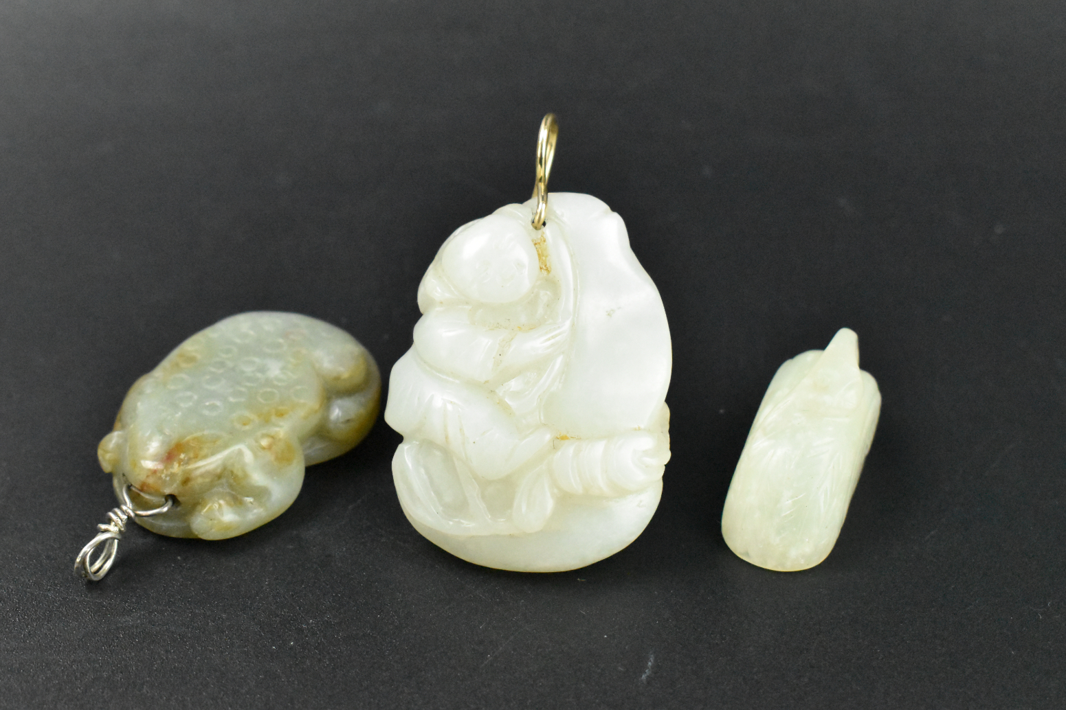 Appraisal: A group of three Chinese jade carved toggles all dated