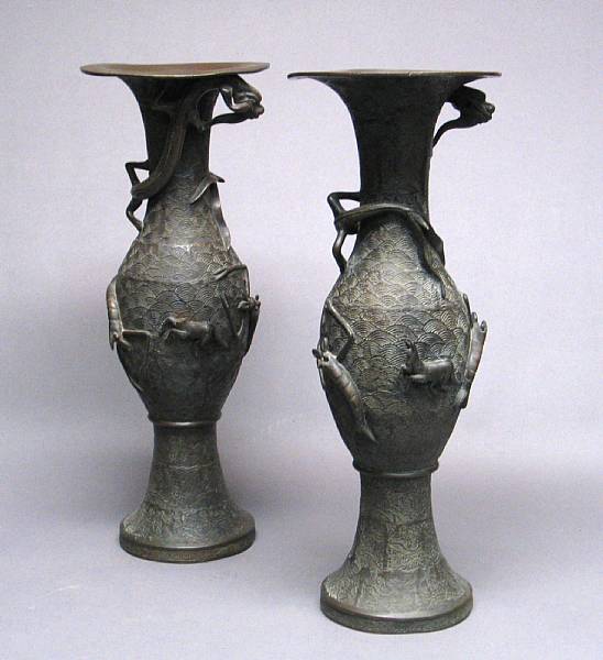 Appraisal: A pair of Japanese cast-bronze vases With a wave-patterned ground