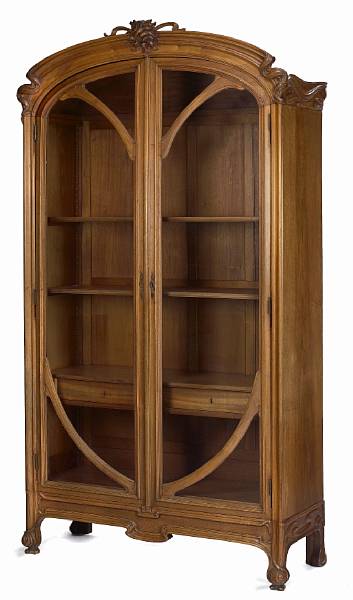 Appraisal: A French Art Nouveau carved walnut armoire BY Louis Schmitt