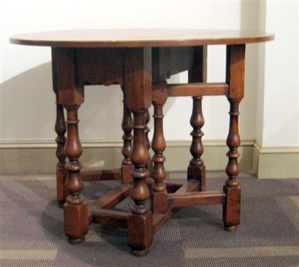 Appraisal: English style Provincial oak table The circular top supported on