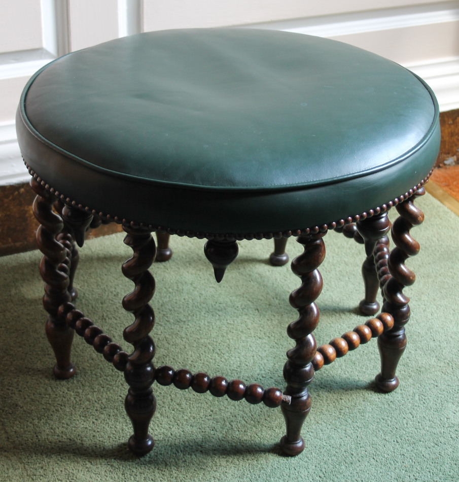 Appraisal: A late Victorian rosewood footstool with a circular green leather