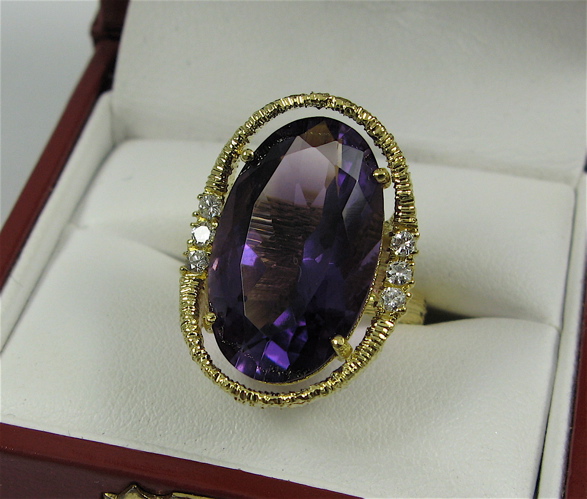 Appraisal: AMETHYST DIAMOND AND K GOLD RING centering a large oval-cut