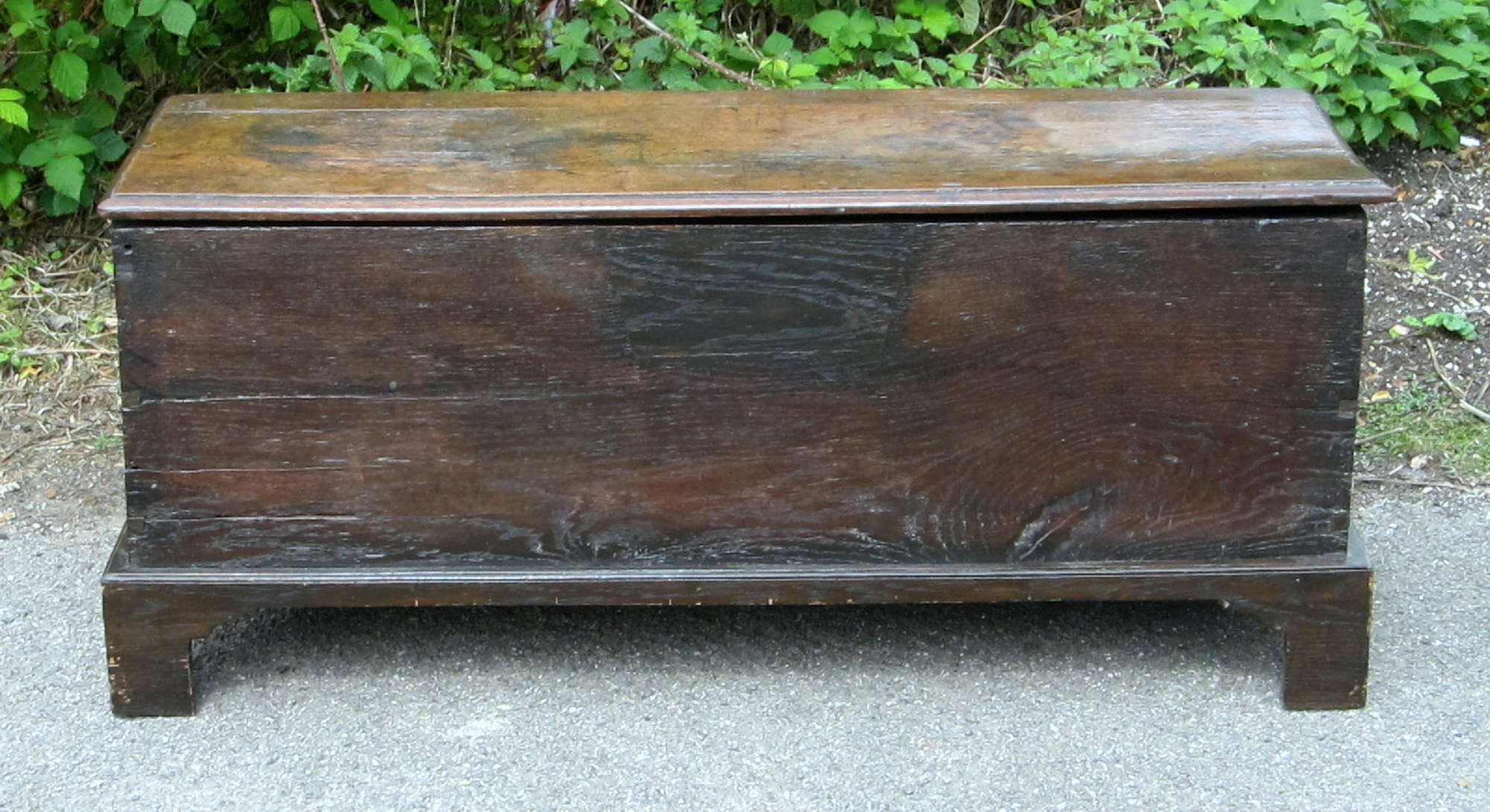 Appraisal: Oak coffer of plank construction on bracket feet