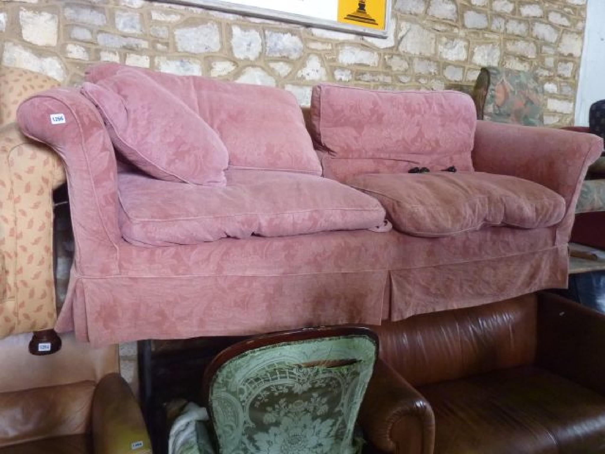 Appraisal: A substantial three seat sofa with pale pink floral embossed