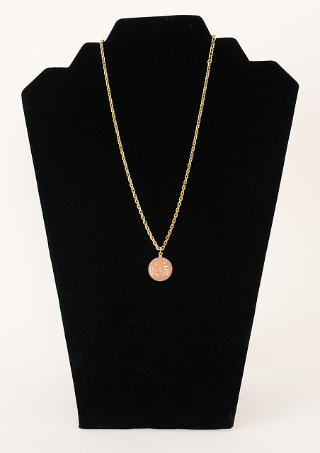 Appraisal: A Chanel necklace with circular pale pink pendant pendant embossed