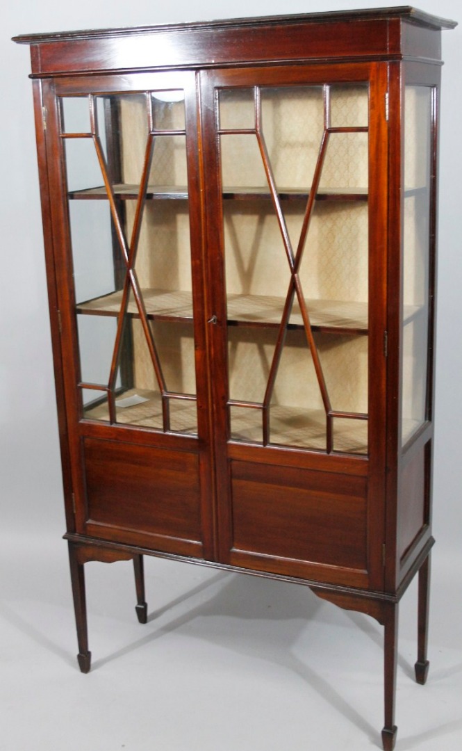 Appraisal: An Edwardian mahogany stained display cabinet the over hanging top