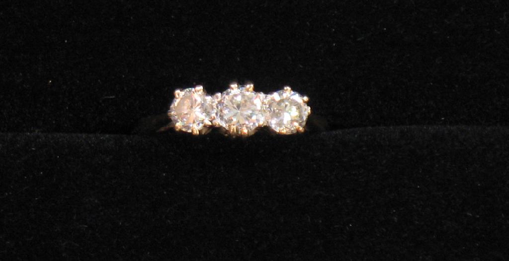 Appraisal: A THREE STONE DIAMOND DRESS RING the three graduated round