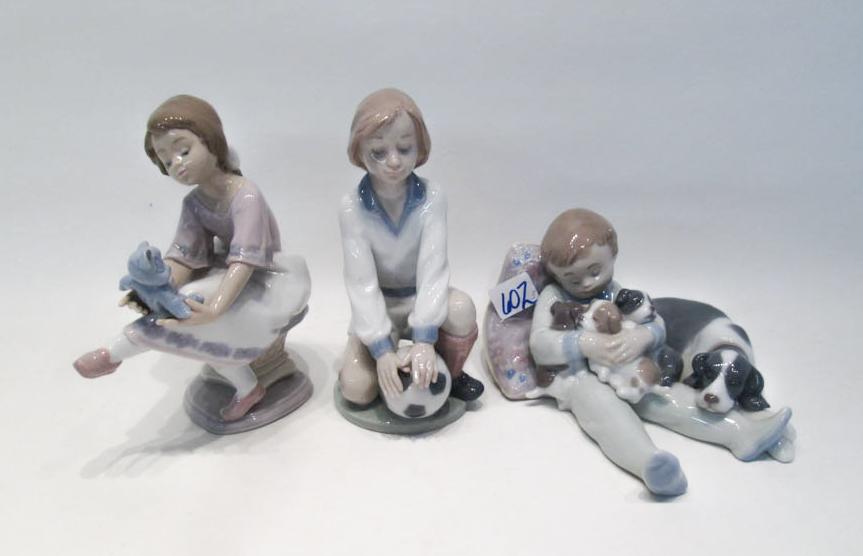 Appraisal: THREE LLADRO PORCELAIN FIGURINES Team Player by sculptor Antonio Ramos