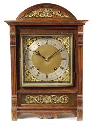 Appraisal: A Victorian oak and gilt brass mounted mantel clock with