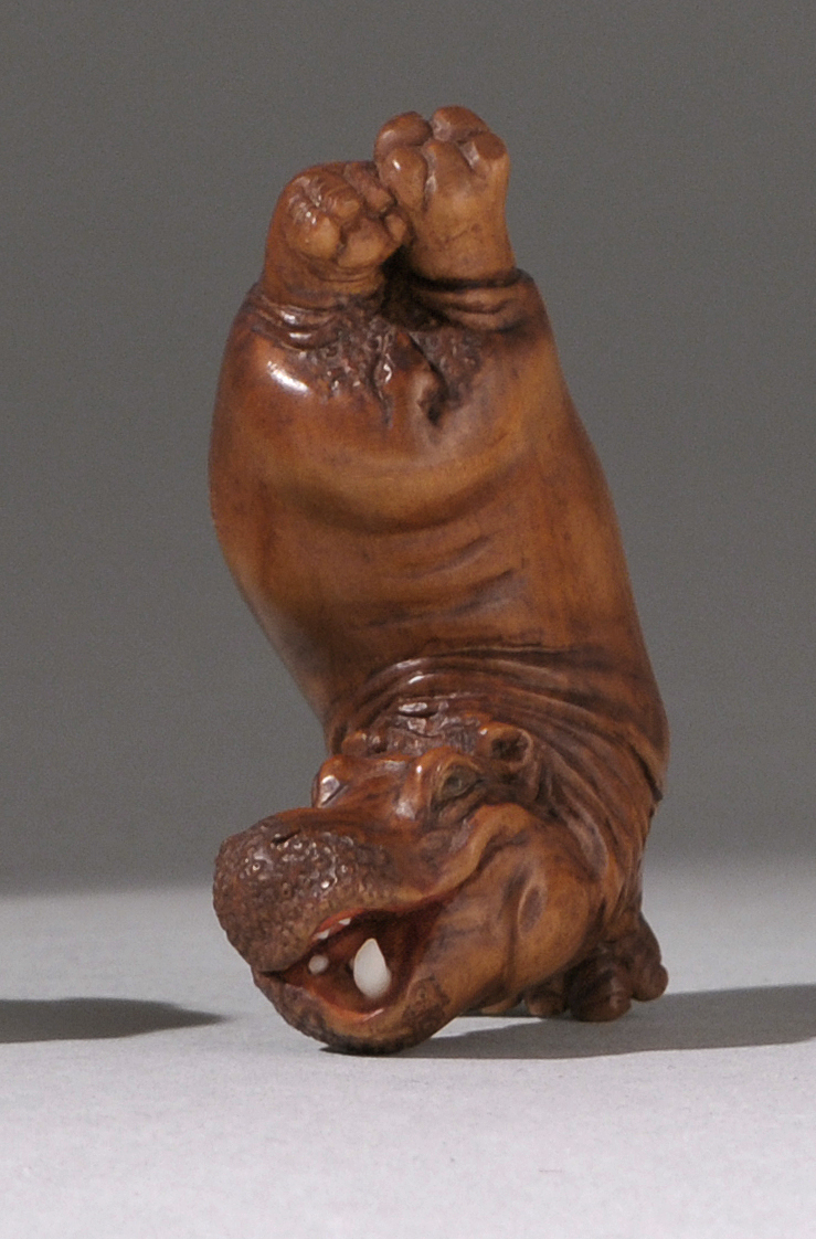 Appraisal: WOOD NETSUKE ContemporaryBy Kozan Depicting a comic hippopotamus with inlaid