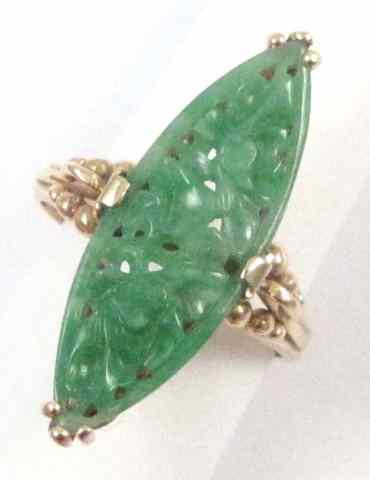 Appraisal: JADE AND FOURTEEN KARAT GOLD RING featuring a single carved