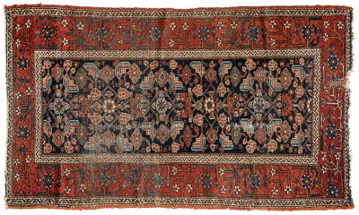 Appraisal: Persian rug repeating floral designs on blue black field brick