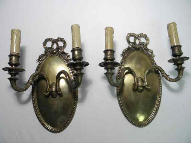 Appraisal: Pair of th century bronze double arm wall sconces Ribbon