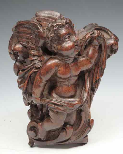 Appraisal: A CARVED MAHOGANY CORBEL of a cherub high