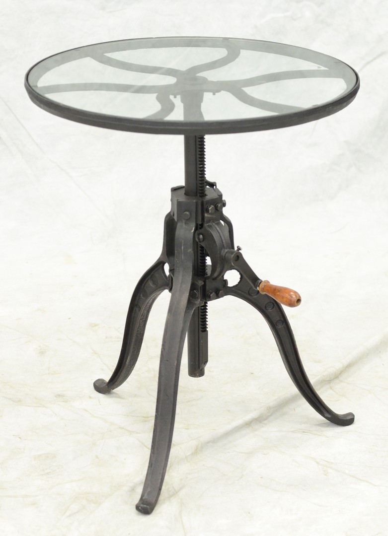 Appraisal: Round cast iron glass top table with hand cranked adjustable