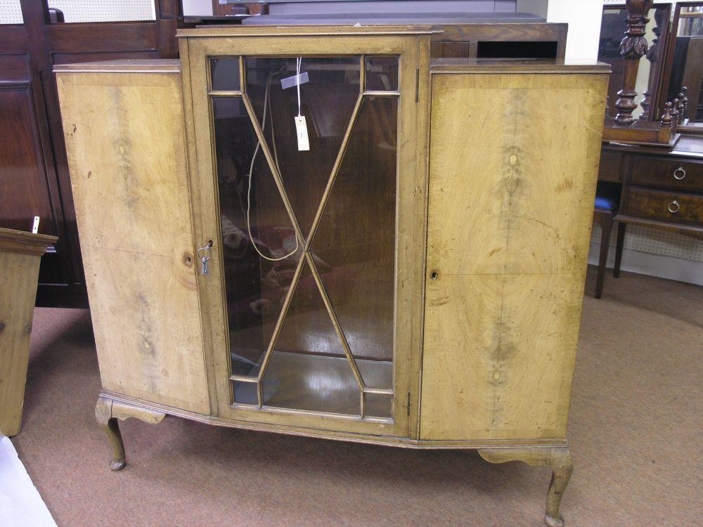 Appraisal: A 's walnut veneered display cabinet single astragal glazed door