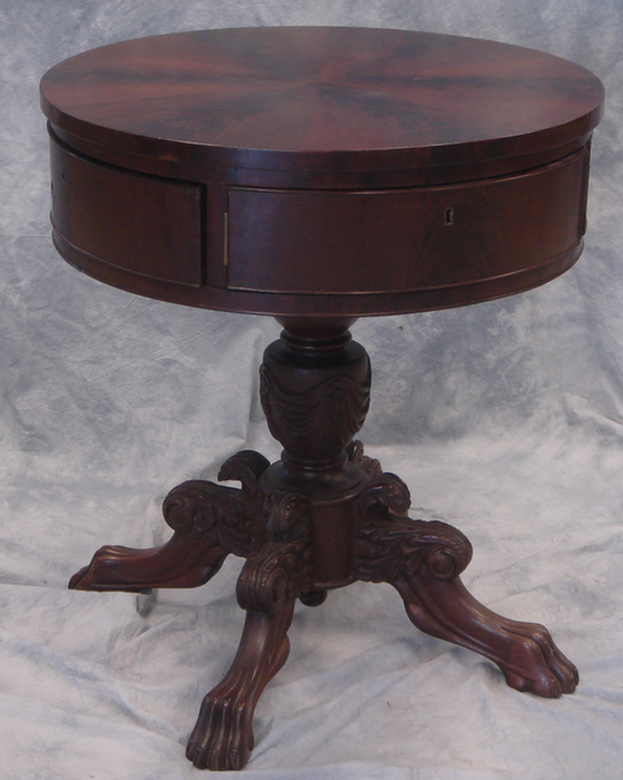 Appraisal: Mahogany Regency drum table swingout drawers carved base pie segmented