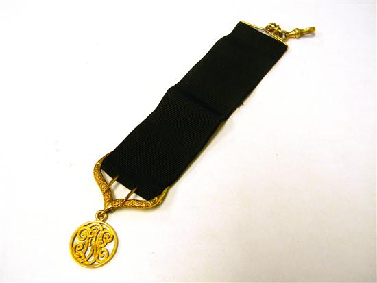 Appraisal: JEWELRY Ribbon watch fob yellow gold filled black grosgrain ribbon