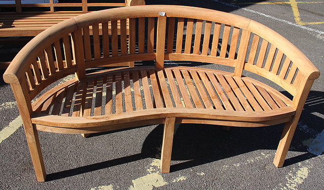 Appraisal: A MODERN TEAK GARDEN SEAT with rounded back serpentine front