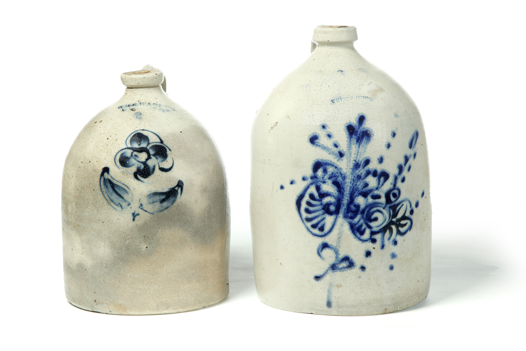 Appraisal: TWO STONEWARE JUGS WITH COBALT FREEHAND DECORATION American th quarter-