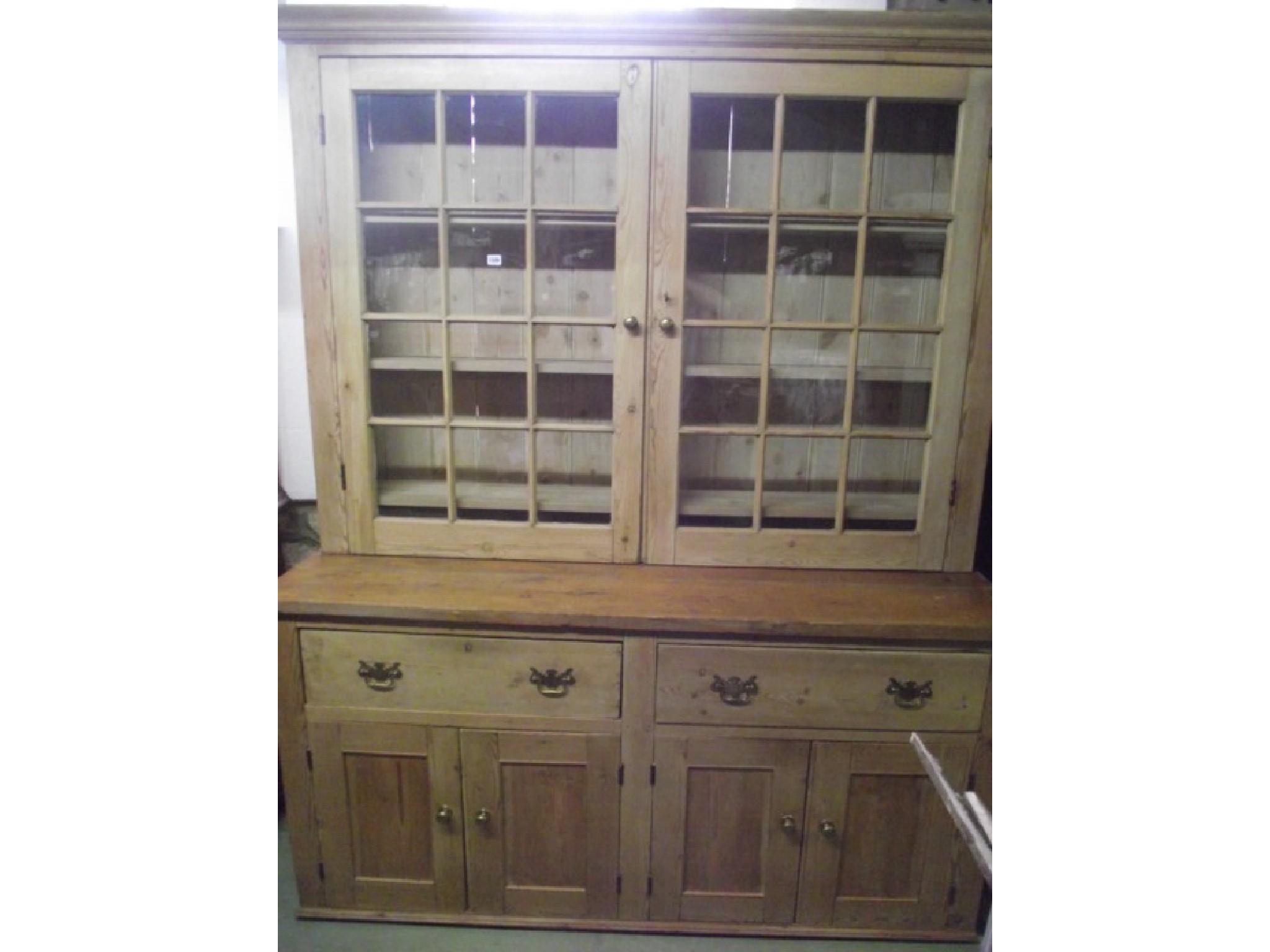 Appraisal: A reclaimed stripped pine kitchen dresser the raised recessed upper