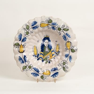 Appraisal: A Dutch Delft Royal portrait dish of lobed form painted