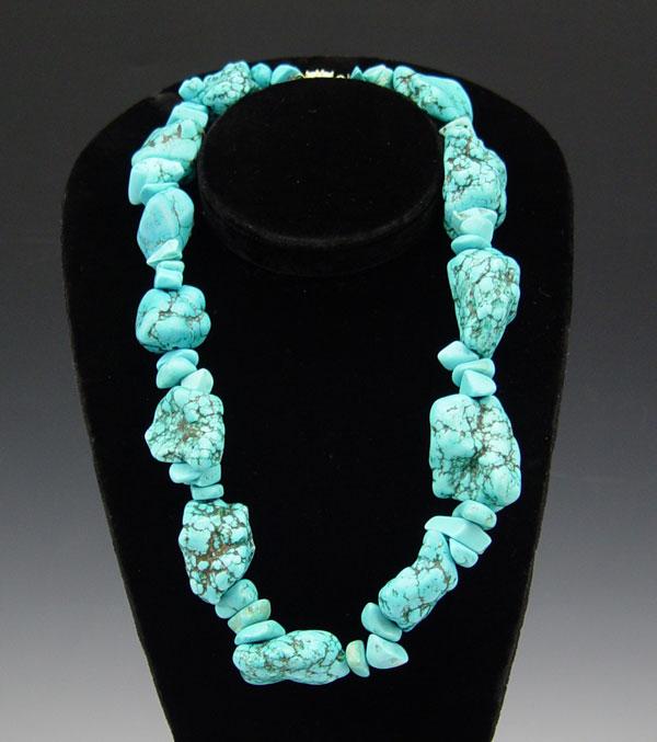 Appraisal: LARGE TURQUOISE NUGGET NECKLACE Trios of small turquoise nuggets spaced