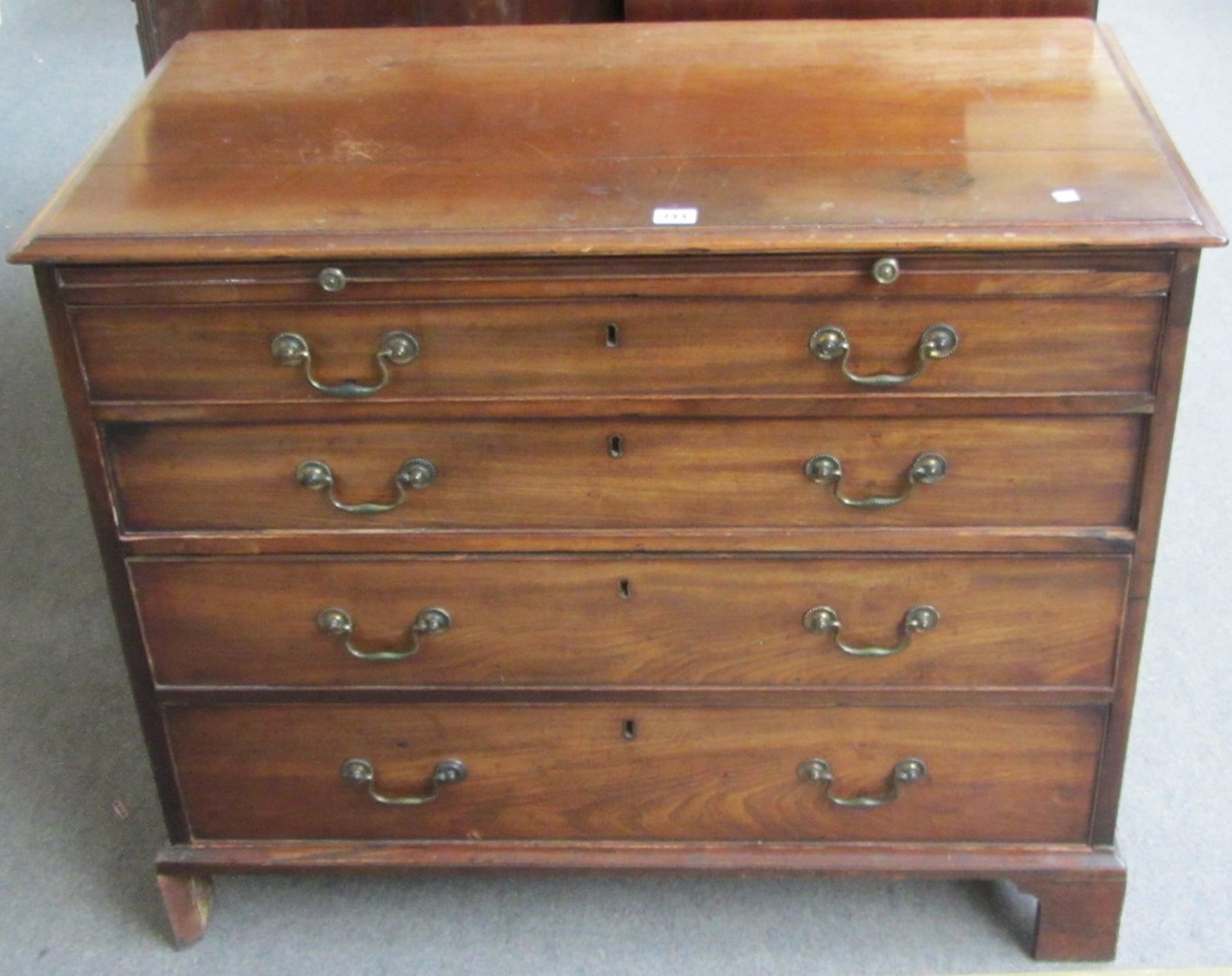 Appraisal: A George III mahogany chest the brushing slide over four