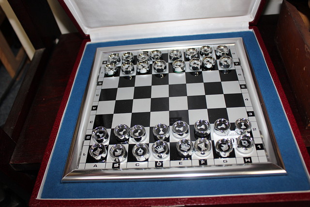 Appraisal: AN ALUMINIUM FRAMED CHESS SET with magnetic pieces the board