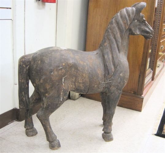 Appraisal: AN EQUESTRIAN WOOD SCULPTURE hand carved and depicted in standing