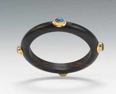 Appraisal: A Carved Mahogany Bangle Bracelet with Labradorite Cabochons Carved wood