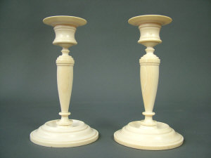 Appraisal: A pair of th century turned ivory candlesticks on stepped