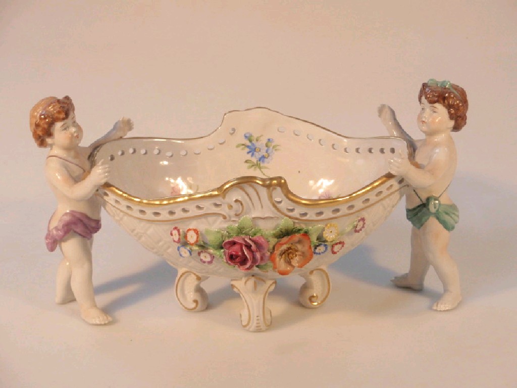 Appraisal: A modern German porcelain putti and basket group cm wide