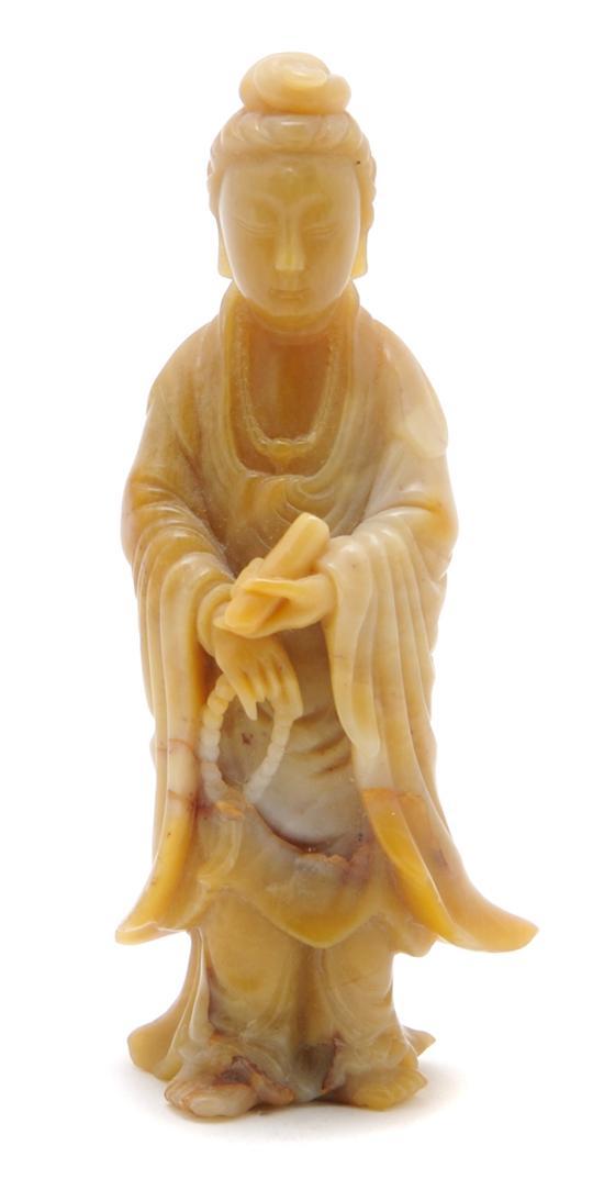 Appraisal: A Chinese Stone Carving of Guanyin depicted in a flowing