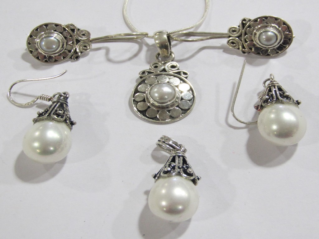 Appraisal: Lot comprising two cultured pearl set silver pendants both with