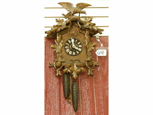 Appraisal: Black forest carved German wall cuckoo clock with weights featuring