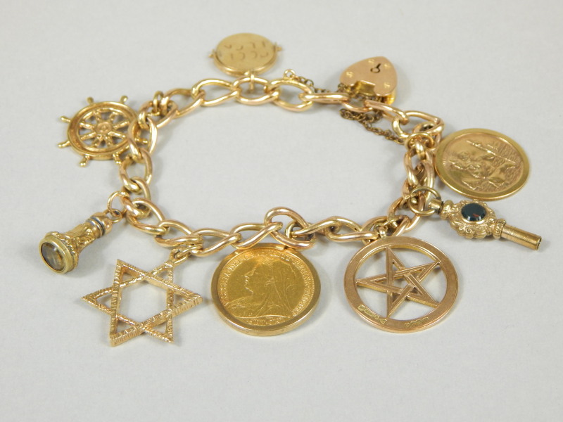 Appraisal: A ct gold charm bracelet set with various charms including