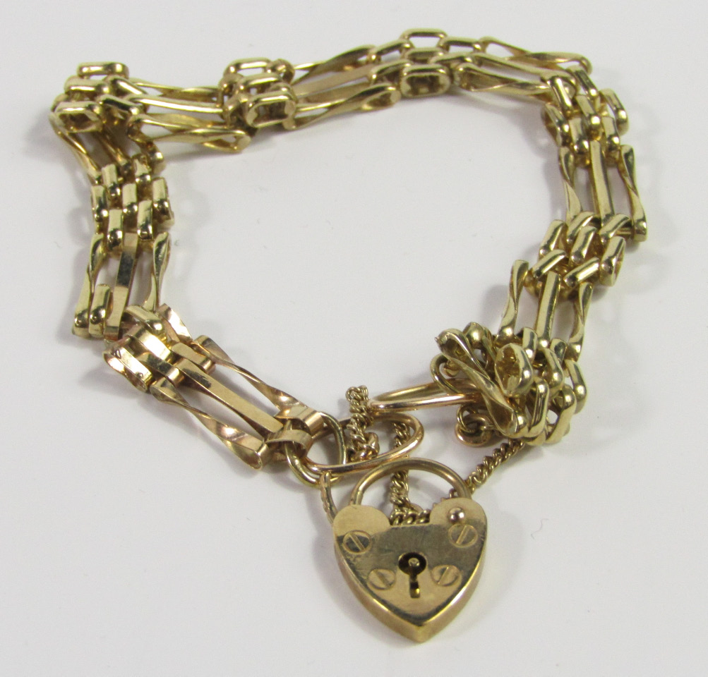 Appraisal: A ct gold triple bar gate bracelet on a heart