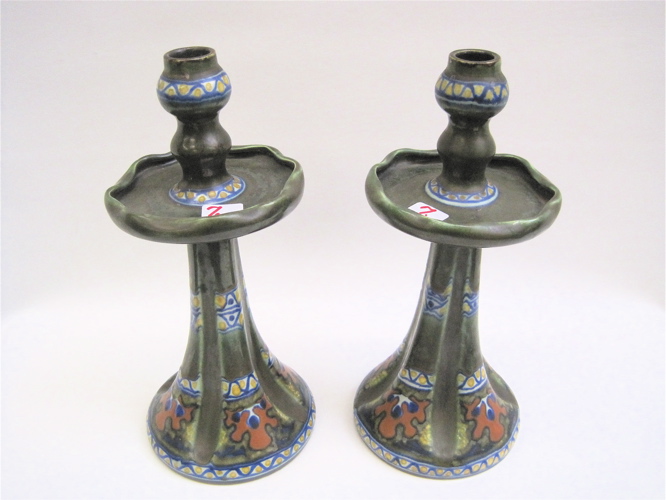 Appraisal: PAIR GOUDA DUTCH POTTERY CANDLE HOLDERS having wax drip upper