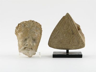 Appraisal: A Gandharan stucco head of Buddha and a stucco triangular